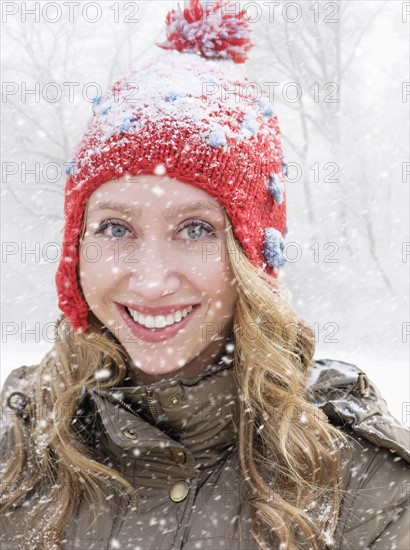 Portrait of woman in red knit hat.