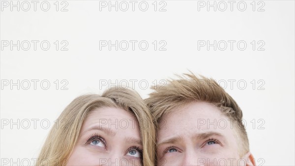 Young couple looking up.