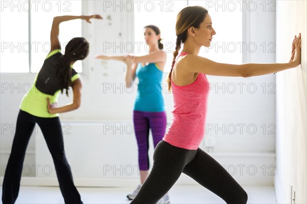 Women exercising at gym.