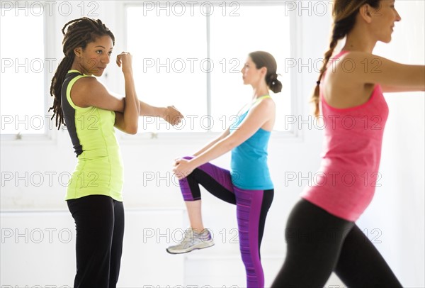 Women exercising at gym.