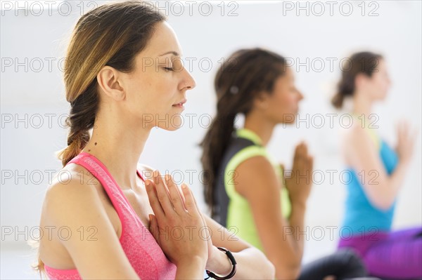 Women in lotus position meditating.