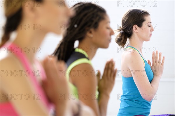 Women in lotus position meditating.