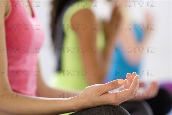 Women in lotus position meditating.