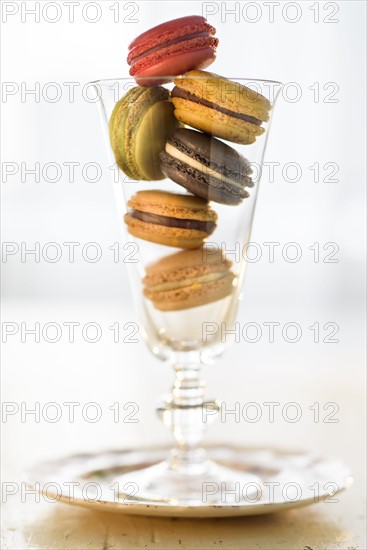 Macaroons inside drinking glass.