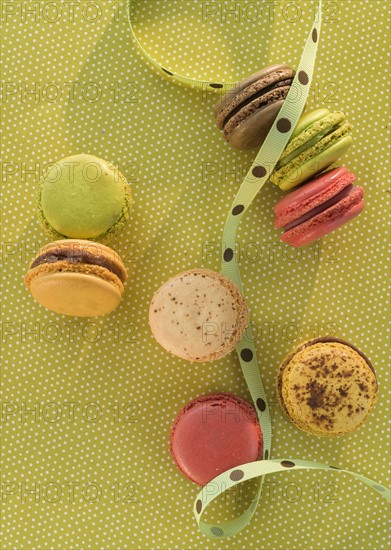 Macaroons on green tablecloth.