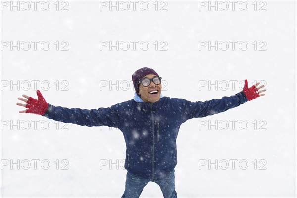 Mid adult man standing on snow.