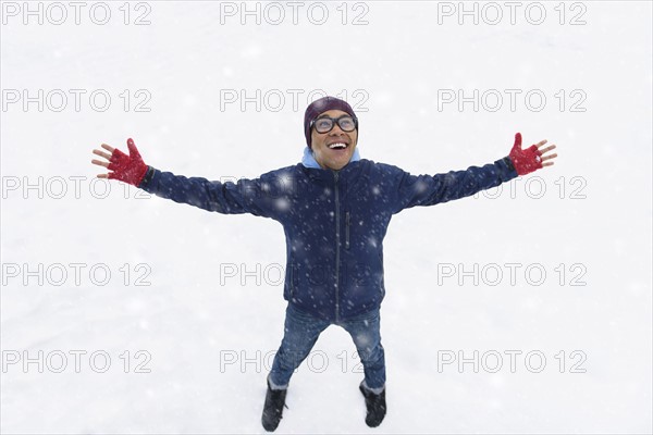 Mid adult man standing on snow.