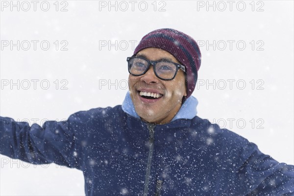 Mid adult man standing on snow.