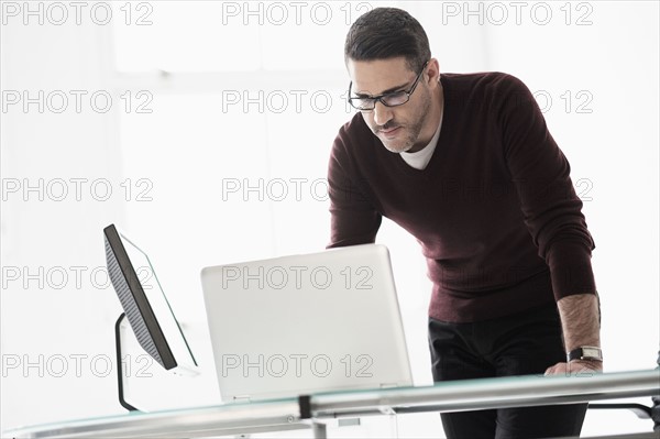 Man using laptop in office.