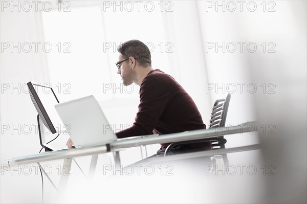 Man using computer in office.