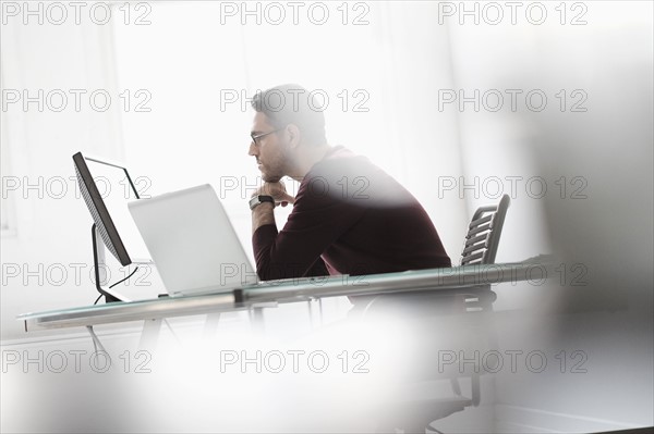 Man using computer in office.