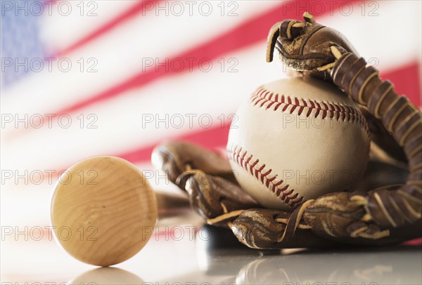 Close-up of baseball glove, ball and bat.