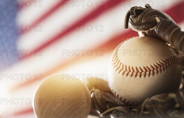 Close-up of baseball glove, ball and bat.
