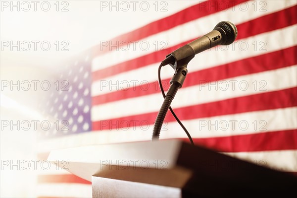 Lectern with American flag in background.