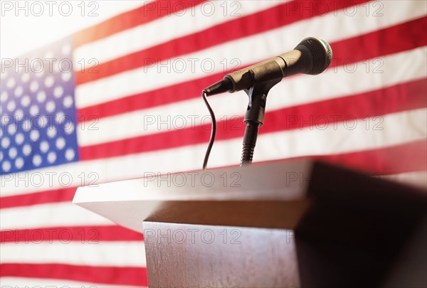 Lectern with American flag in background.