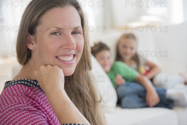 Portrait of mid adult woman with children (6-7, 8-9) in background