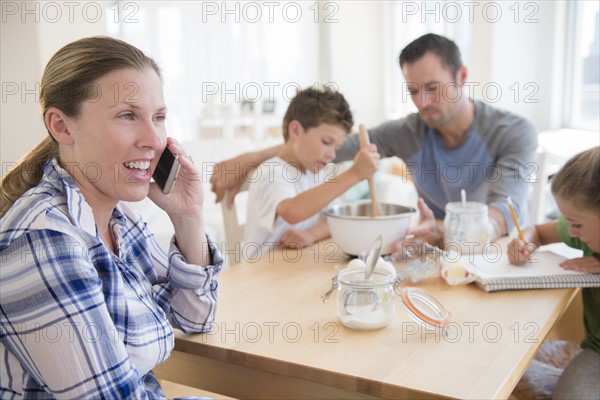 Family with two children (6-7, 8-9) sitting at table