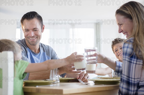 Family with two children (6-7, 8-9) making a toast