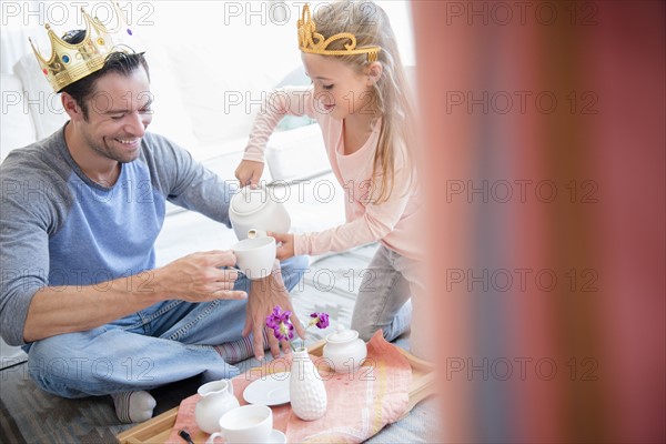 Daughter (6-7) having tea party with father