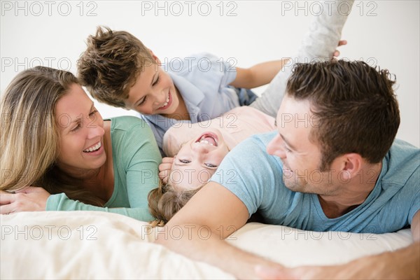 Family with two children (6-7, 8-9) in bedroom