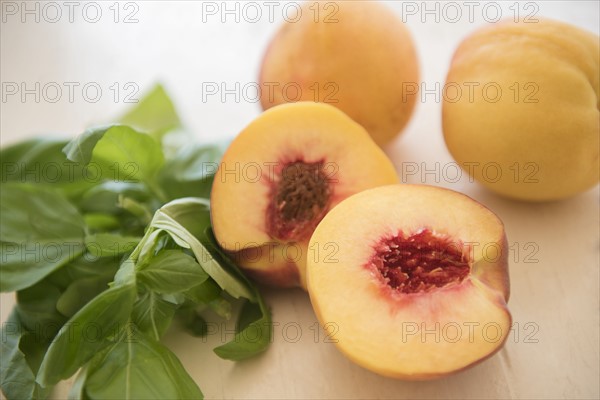Peaches and basil on table
