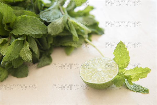 Mint and halved lemon on table