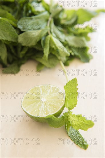 Mint and halved lemon on table