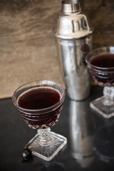 Alcohol in wine glass and cocktail shaker