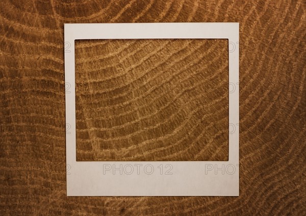 Empty Polaroid frame on wood