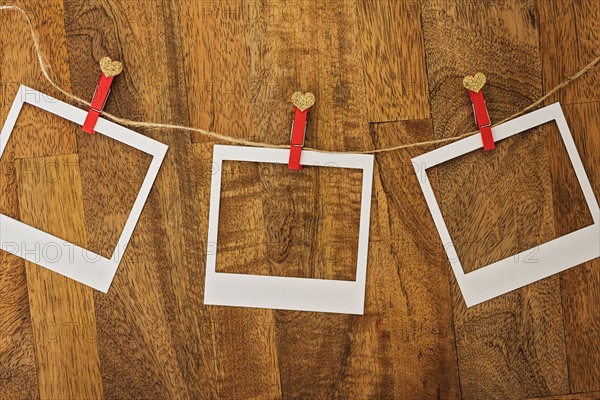 Empty Polaroid frames in a row on wood