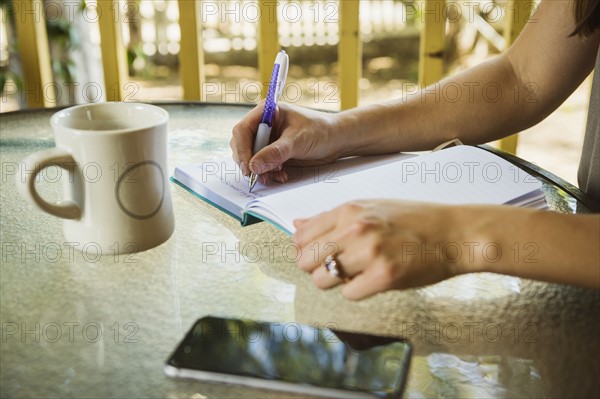 Young woman writing in diary