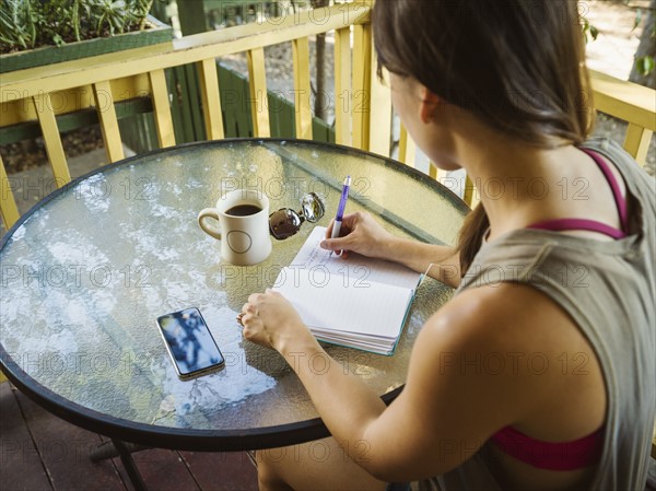 Young woman writing in diary