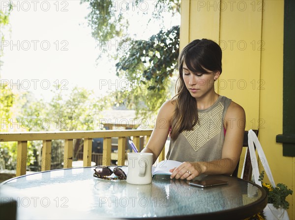 Young woman writing in diary