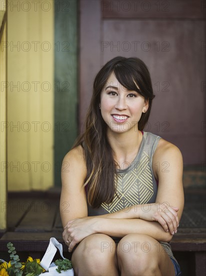 Portrait of young woman on porch