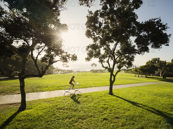 Young woman cycling in park