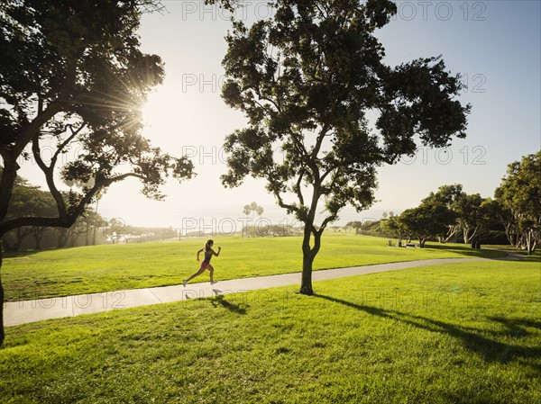 Young woman running in park