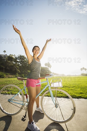 Young woman with bicycle in park