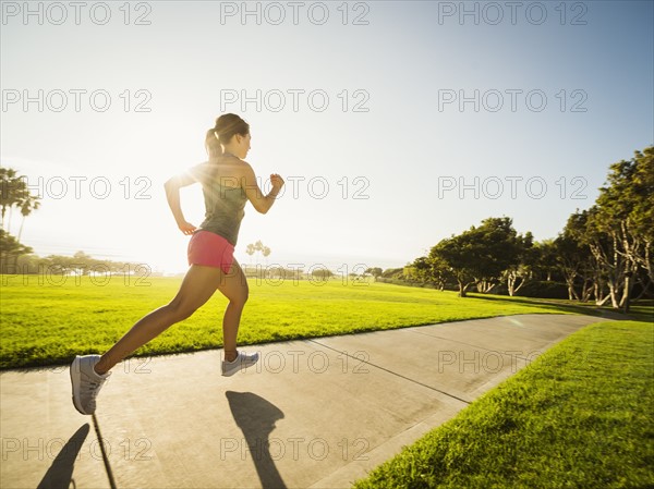 Young woman running in park