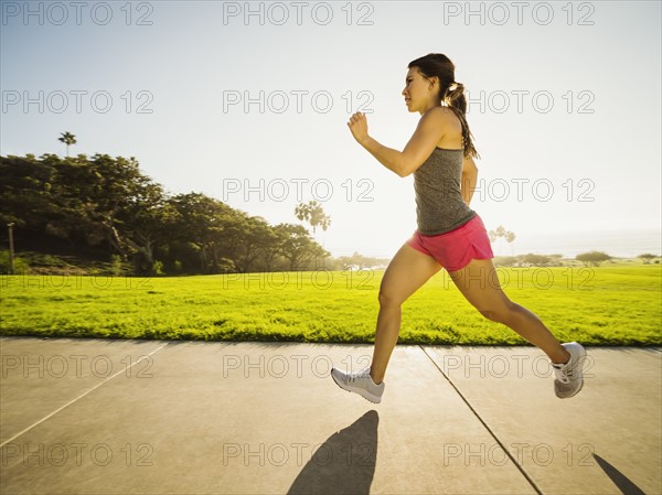 Young woman running in park