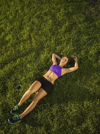 Young woman lying on grass