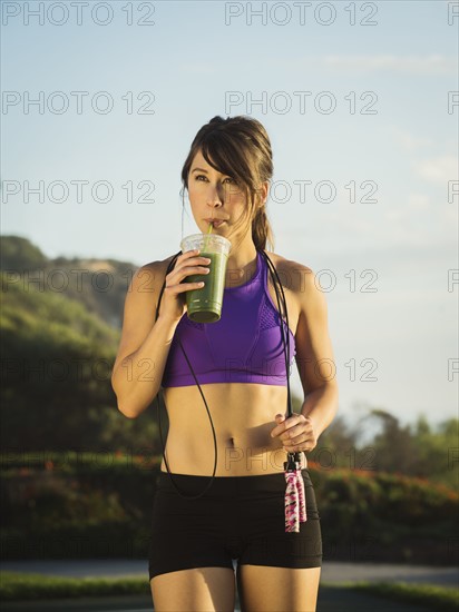 Young woman drinking smoothie