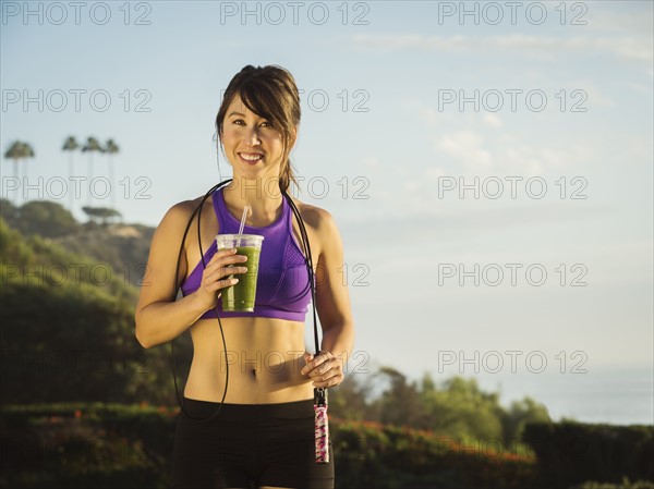 Young woman holding smoothie