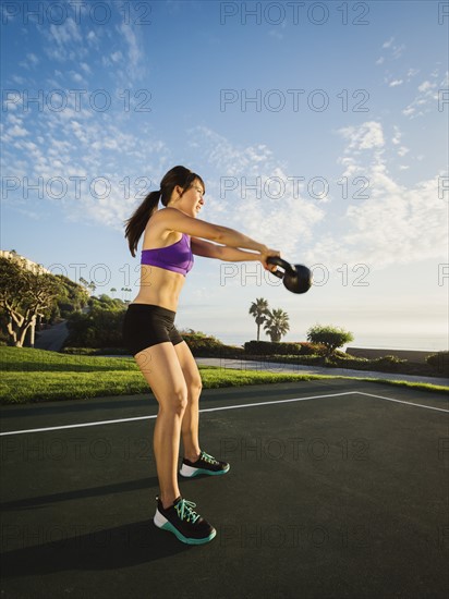 Young woman exercising with kettlebell