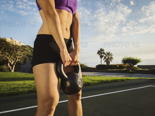 Young woman exercising with kettlebell