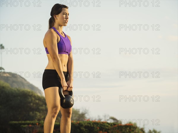 Young woman exercising with kettlebell