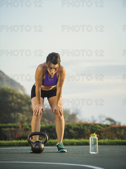 Young woman bending over resting