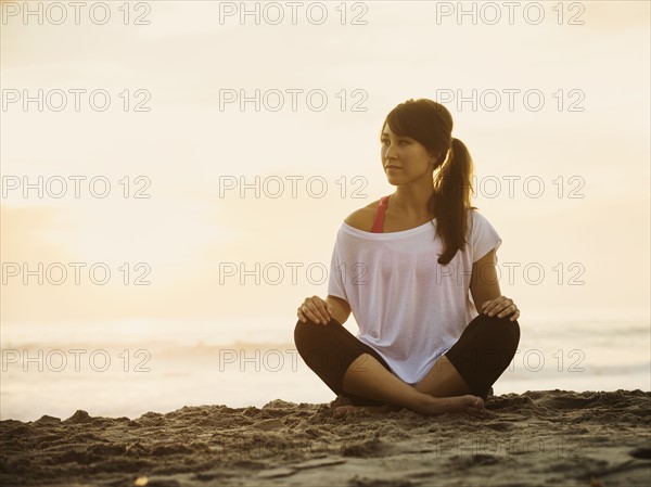 Young woman sitting on beach