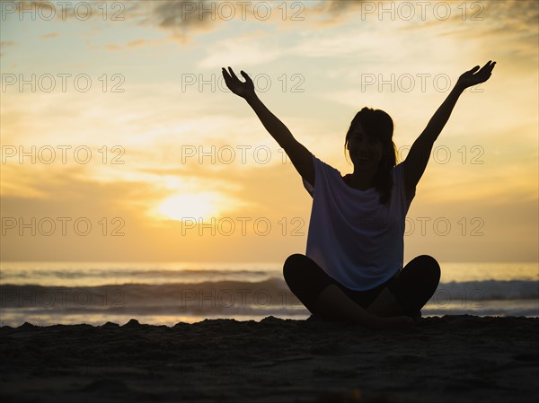 Young woman sitting on beach