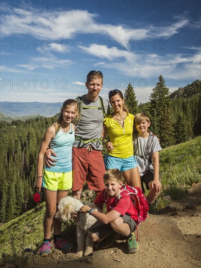 Parents and children (10-11, 12-13, 14-15) with dog