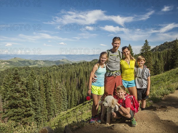 Parents and children (10-11, 12-13, 14-15) with dog